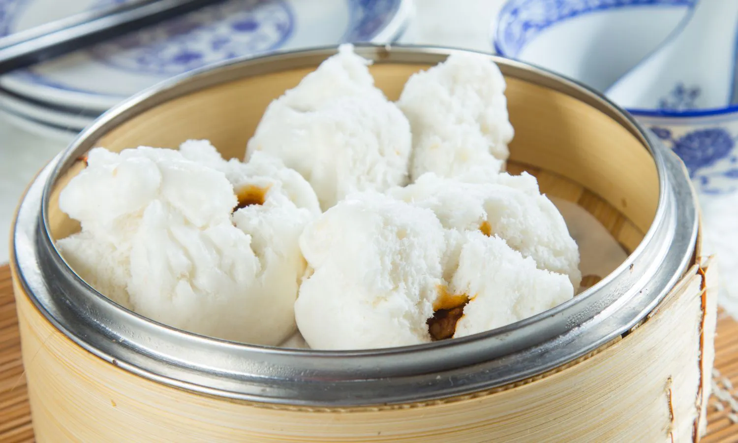 Soft steamed char siu bao with oozing barbecue pork filling