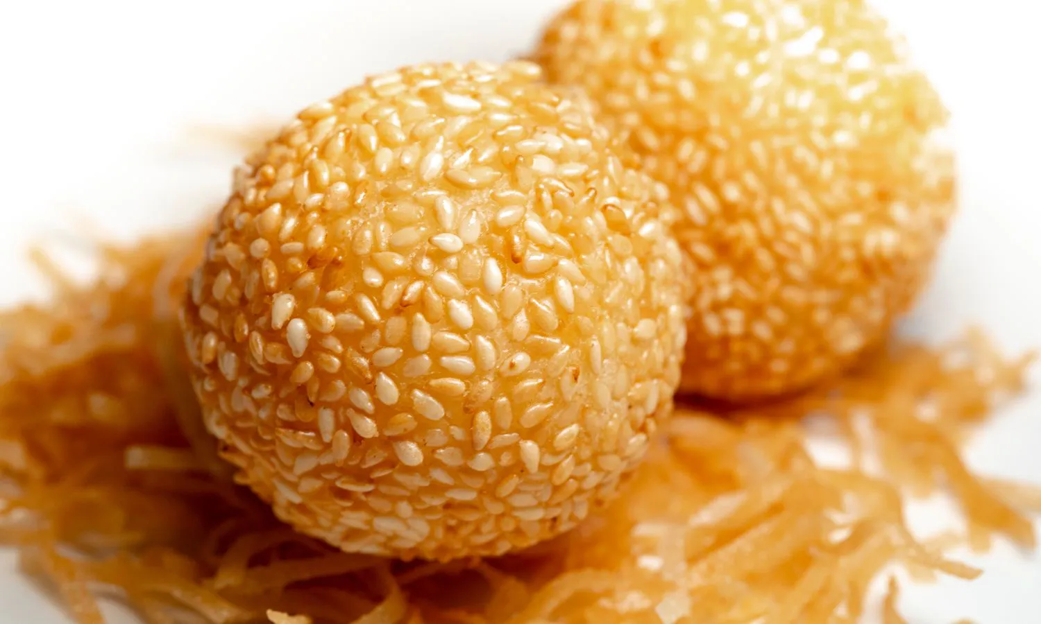 Golden fried sesame balls coated with white sesame seeds